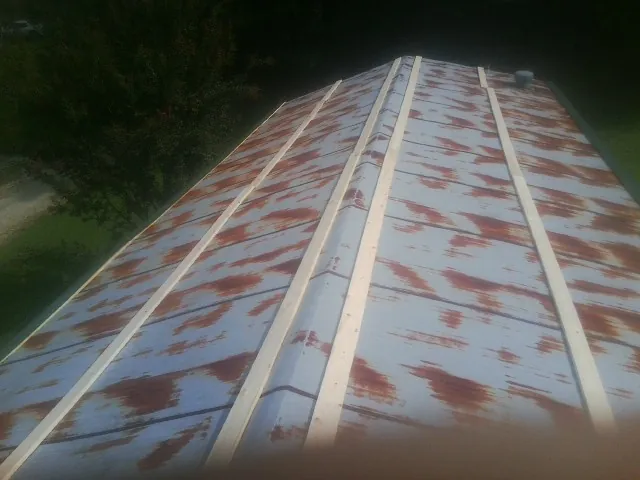 Rusted metal roof panels with new wood purlins before replacement — Storm Damage Roof Repair in Galt by Roofing Brothers